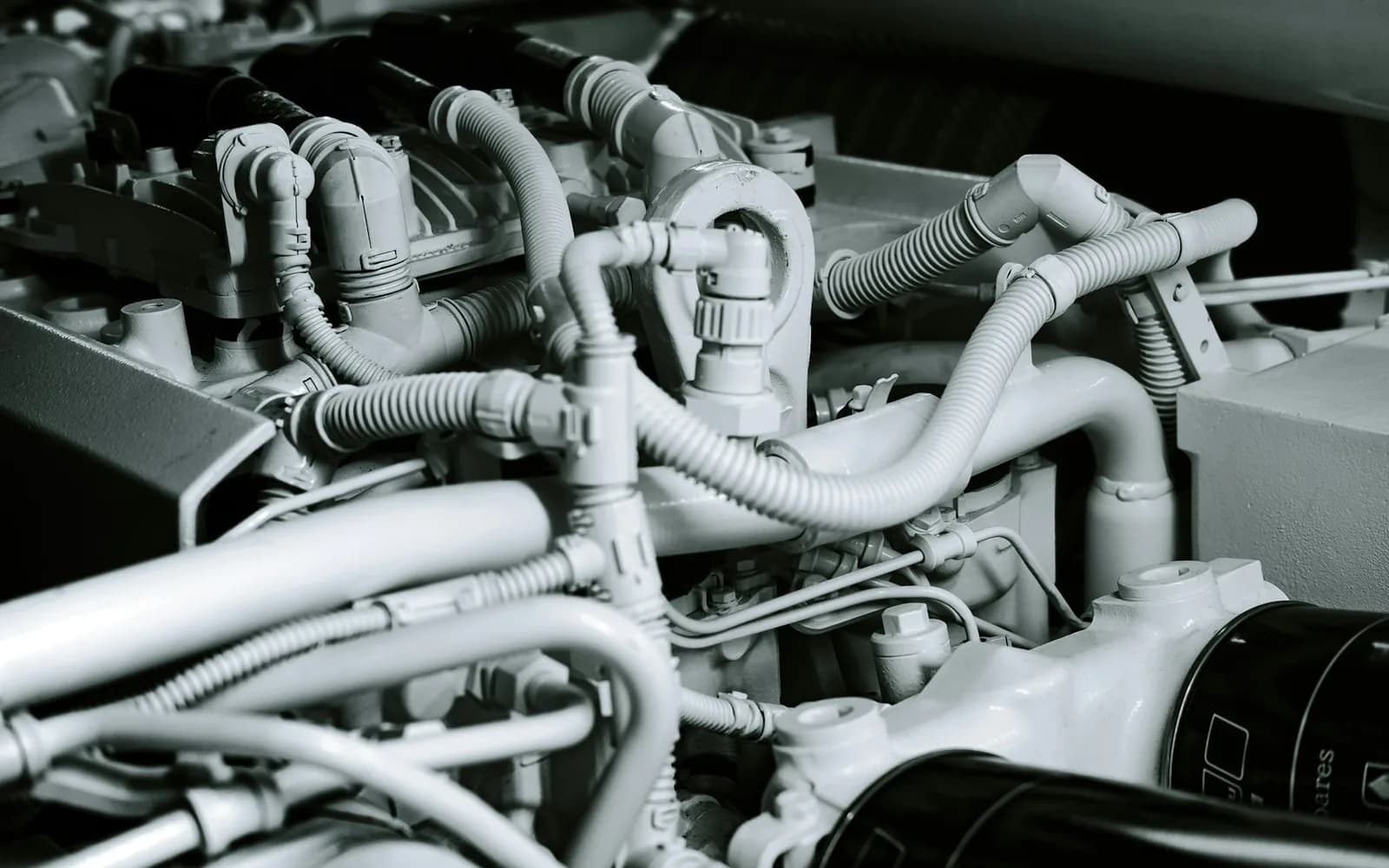 Pipes and mechanical connections on a yacht diesel engine; illustrative photograph