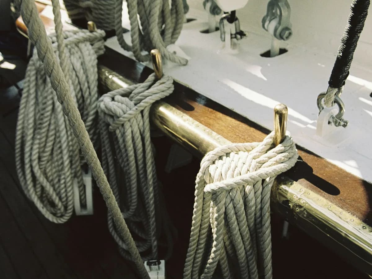 Rope and brass deck hardware on a wooden boat